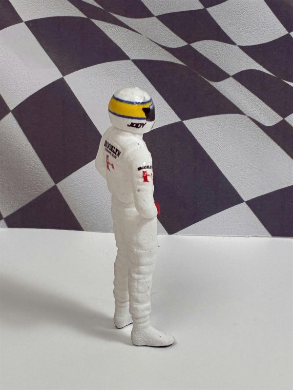 a toy astronaut in front of a checkered flag