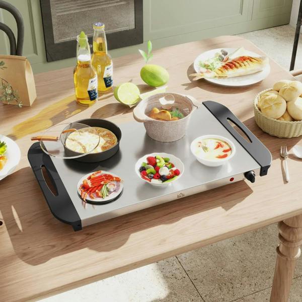 Silver 4-tray electric food warmer with clear pans holding multiple hot dishes