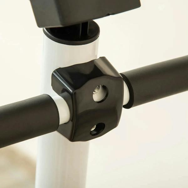Black handlebar joint with adjustment screw on white stepper frame