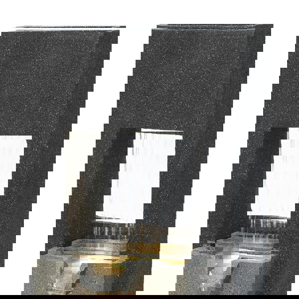 Sleek black stone electric water feature with cascading water, illuminated from below, creating a tranquil ambiance