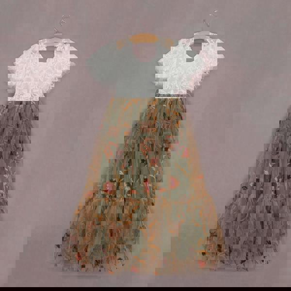 Children's dress with floral pattern on a hanger against a plain background