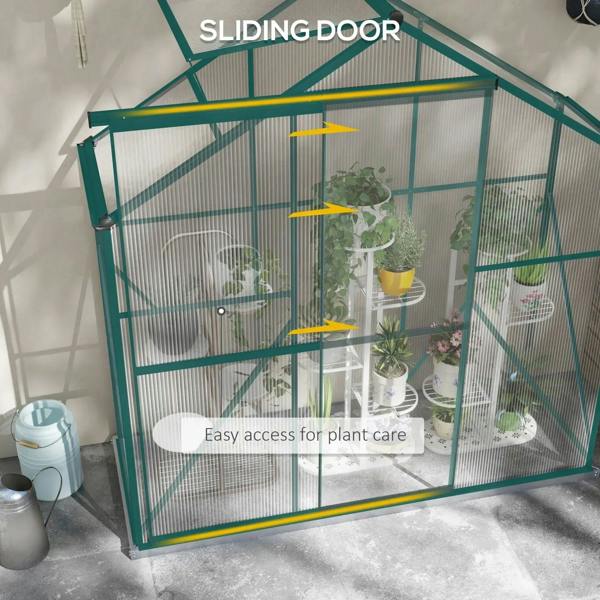 Green polycarbonate greenhouse with sliding door and yellow handle accents