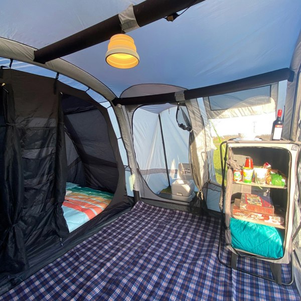 Image of OLPRO Silicone Camping Lantern, dimmable 240V, in use inside the living area of a large family tent/awning.