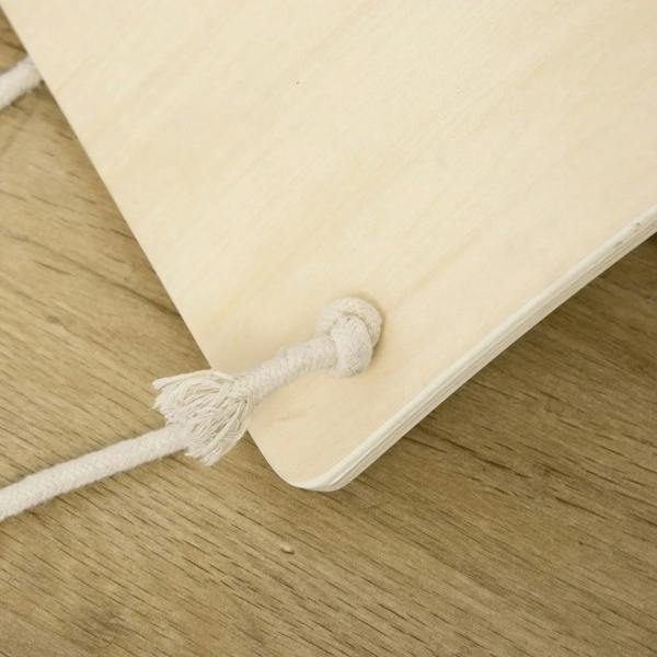 Natural wood balance board with knotted rope attachment on underside