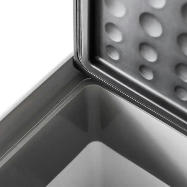 Grey cooler interior with metal cooling plate and textured drainage surface