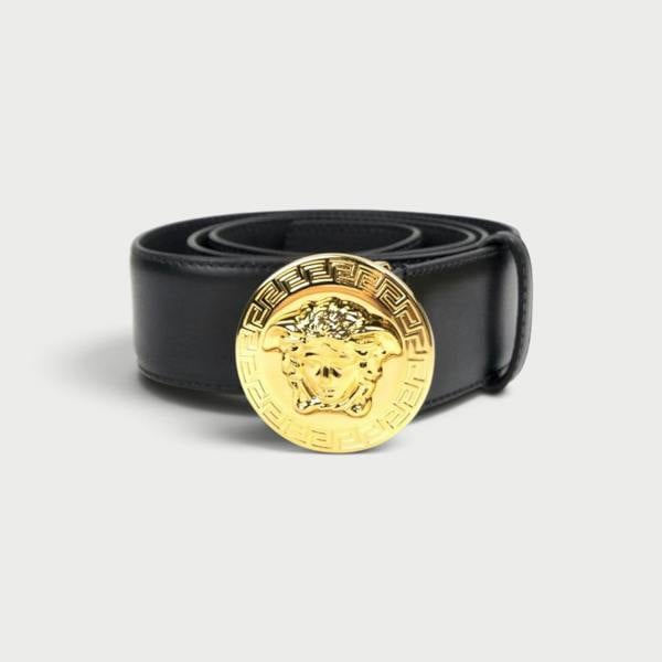 Supplied Fashion black leather belt with a round gold Medusa head buckle featuring Greek key detailing.