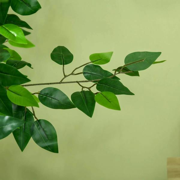 Green artificial ficus leaves on branching stems, close-up