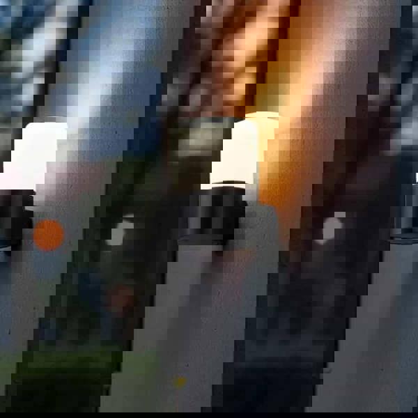 black outside wall mounted light fitted on a textured outside wall 