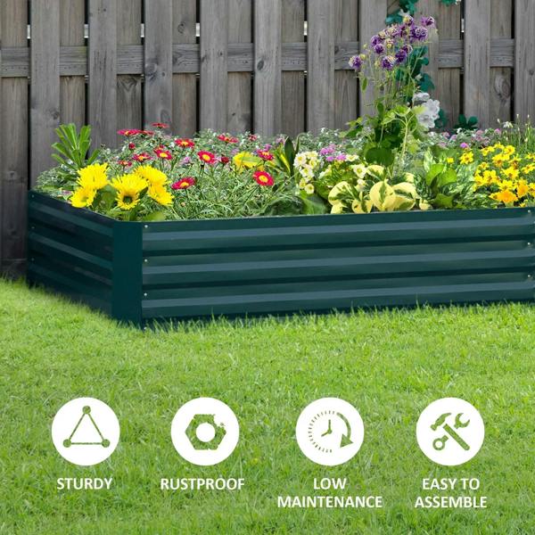 Green metal raised garden bed planter box with mixed flowers and grassy base