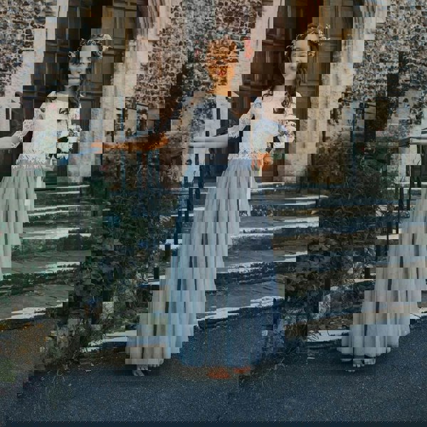 young flower girl stood by steps