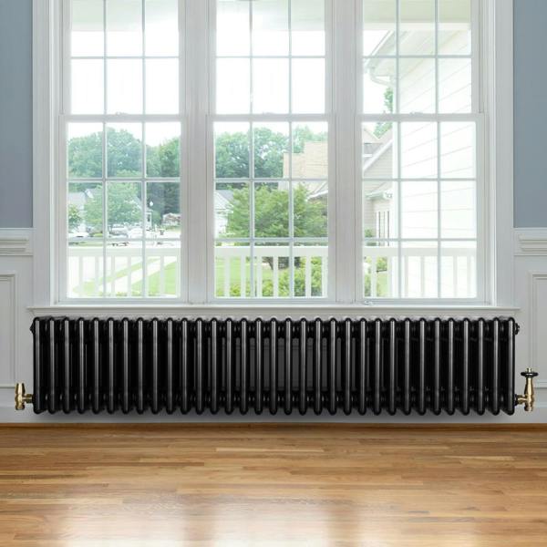 Traditional black 4 column radiator, 300 x 1505mm, features a sleek finish, positioned under a large window with natural light