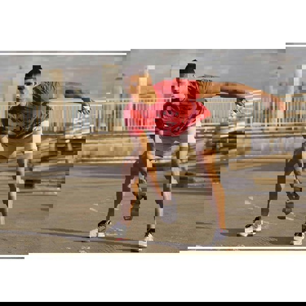 Man performing a kettlebell swing outside using a Reebok 8kg Cast Iron Kettlebell