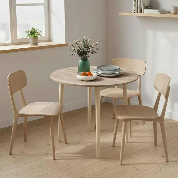 Round drop-leaf dining table with natural wood finish and four simple wood legs