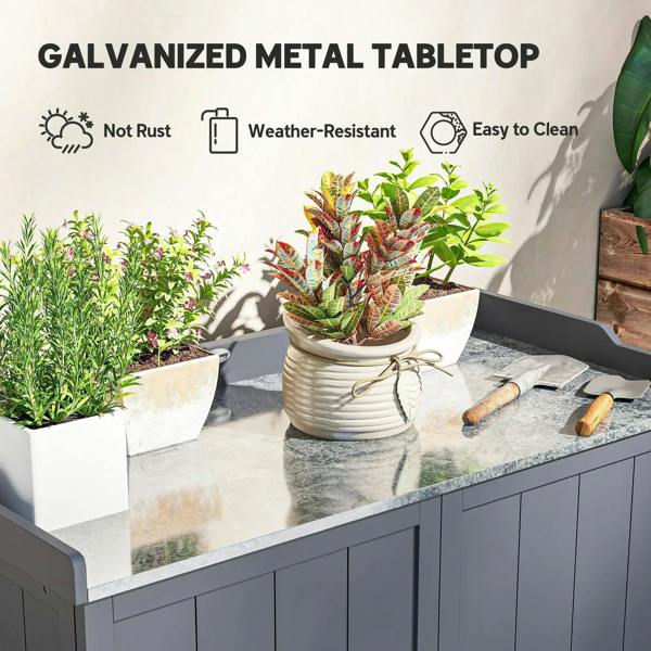 Grey cabinet with galvanized metal tabletop, holding potted plants and tools
