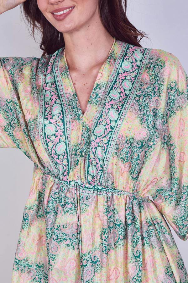 Woman wearing a floral dress with a plain background