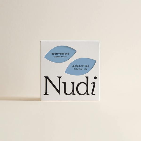 Nuditea bedtime blend luxury tea box in pastel blue and navy leaves in a minimalistic style.