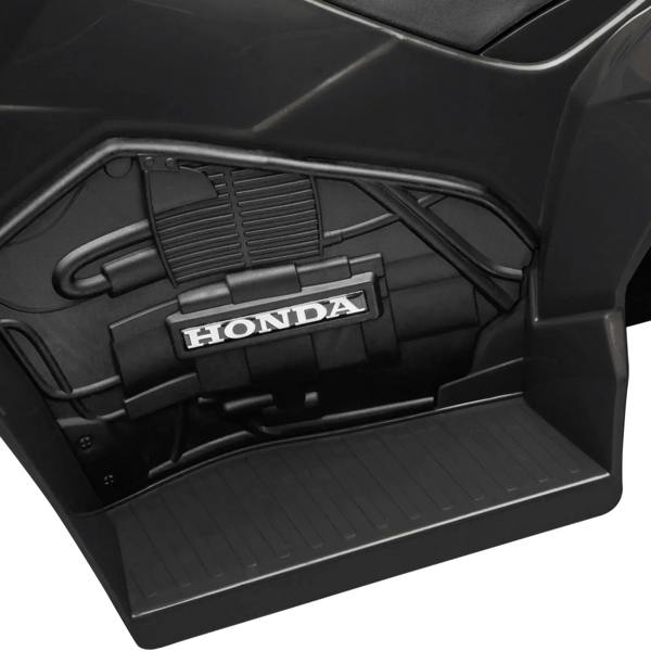 Black electric quad bike battery compartment with Honda logo, close-up