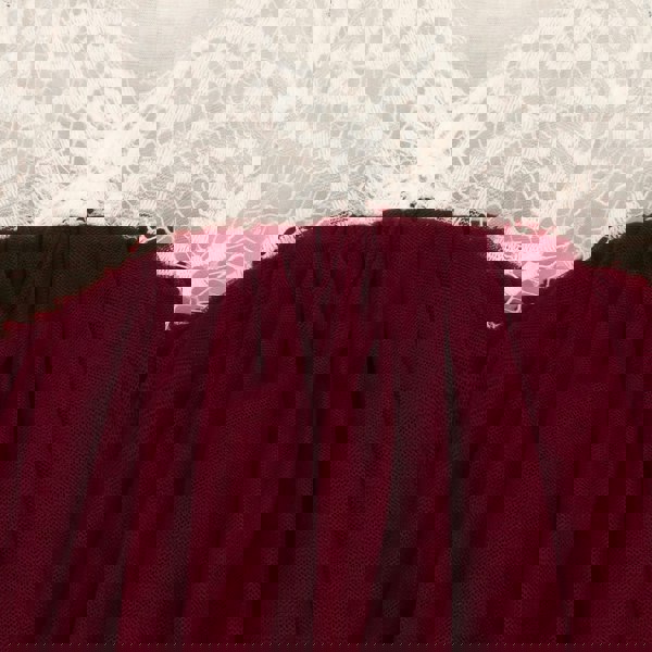 Close-up of a burgundy fabric with lace trim