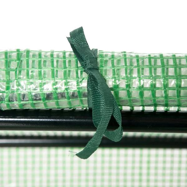 Green fabric roll-up strap detail on a green PE greenhouse cover