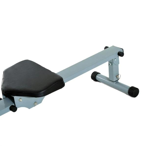 Rowing machine close-up of padded seat, support frame, and end roller feet in grey and black