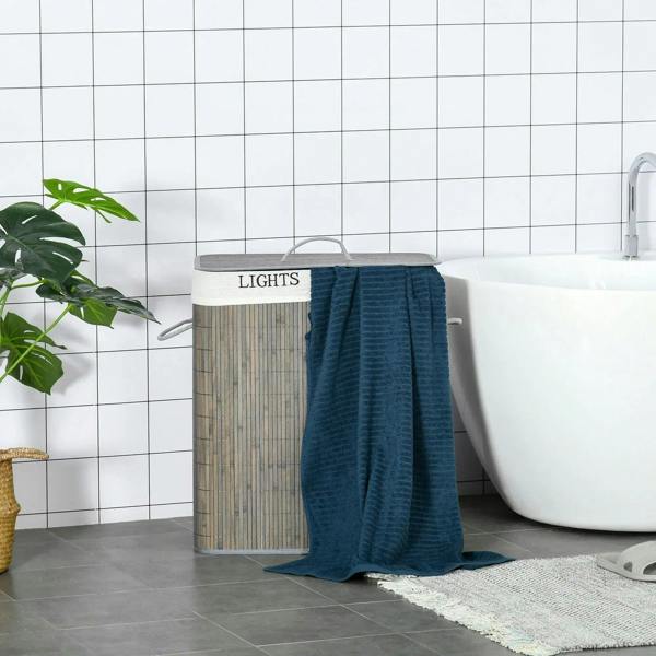 Grey laundry hamper with lid and string handle, with blue towel hanging over the side