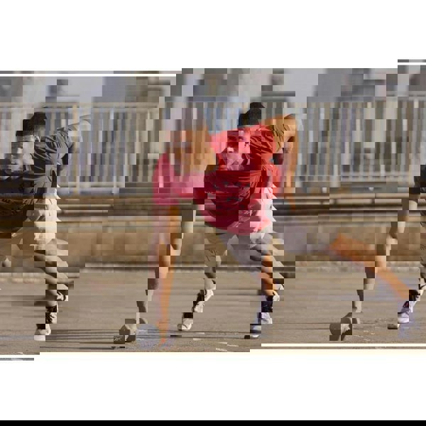 Man exercising outside using Reebok 4kg Dumbbells