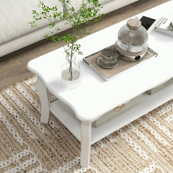 White coffee table with lower shelf and curved legs, shown from a side angle