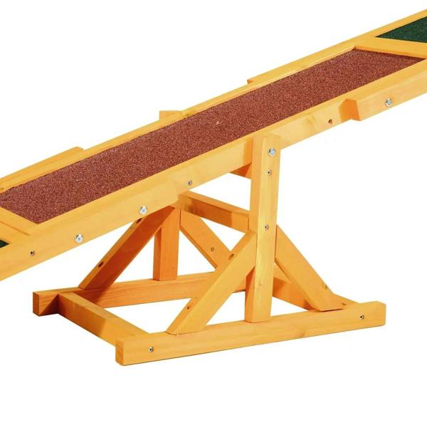 Close-up wooden training seesaw with brown textured walkway and green pad section