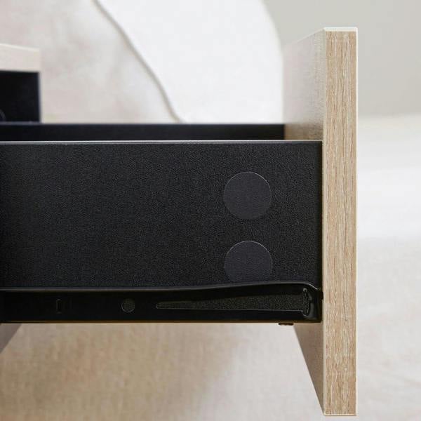 Close-up of drawer rail and dark interior inside a floating bedside cabinet