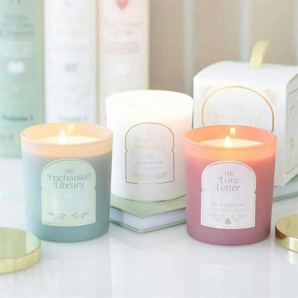 Three scented candle jars with printed labels on display
