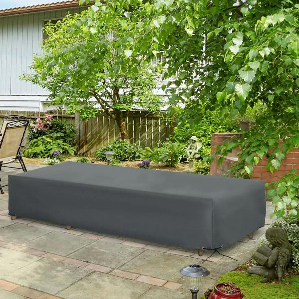 Grey outdoor rattan bench protective cover on patio, fully draped over bench