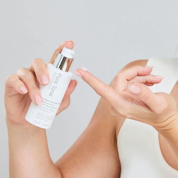 Kimberley Walsh dispensing Pure Tone Aesthetics Polynucleotide Serum onto her fingertip
