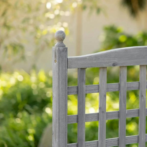 Grey trellis corner post with rounded finial on raised planter box