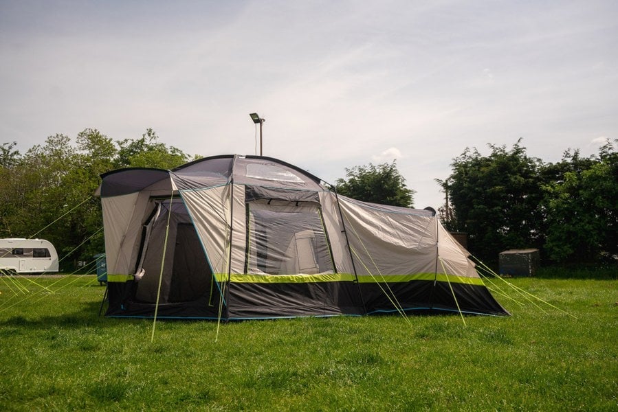 The Hive 6 Berth Poled Tent by OLPRO pitched in a campsite.