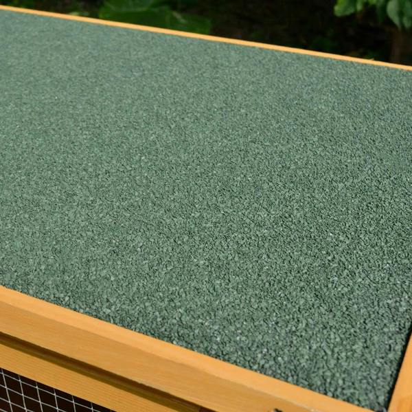 Green asphalt roof panel on a wooden small animal hutch