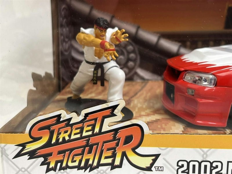 a toy figurine of a man in a white robe and a red car