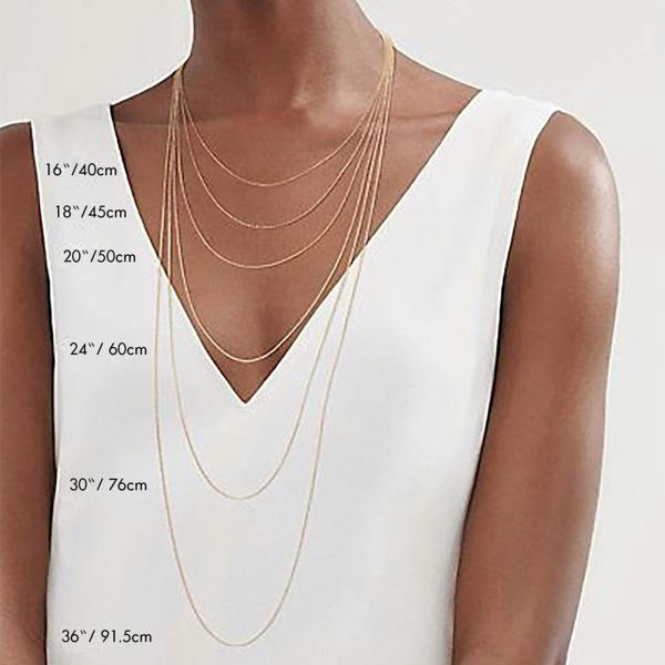 Kati Kaia amethyst mala necklace worn as layered gold chains on model in white top showing lengths