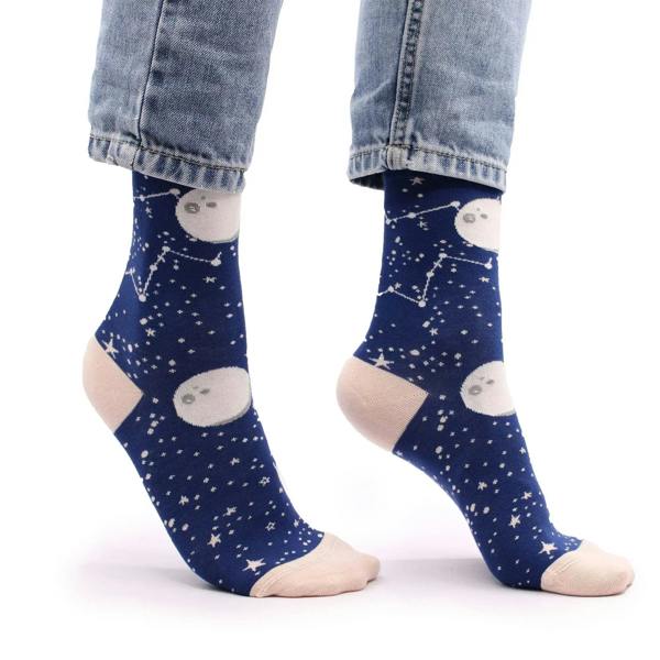 Navy bamboo crew socks with moon and star faces; worn with denim jeans
