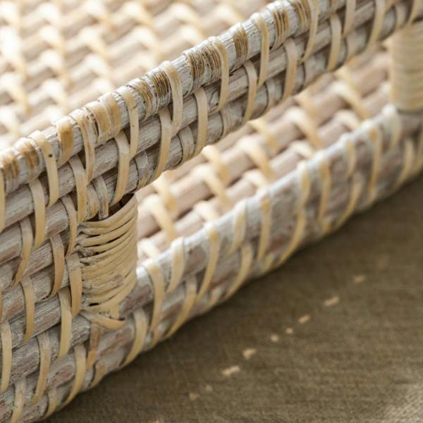 Detailed view of the integrated cutout handle on a whitewash rattan tray.