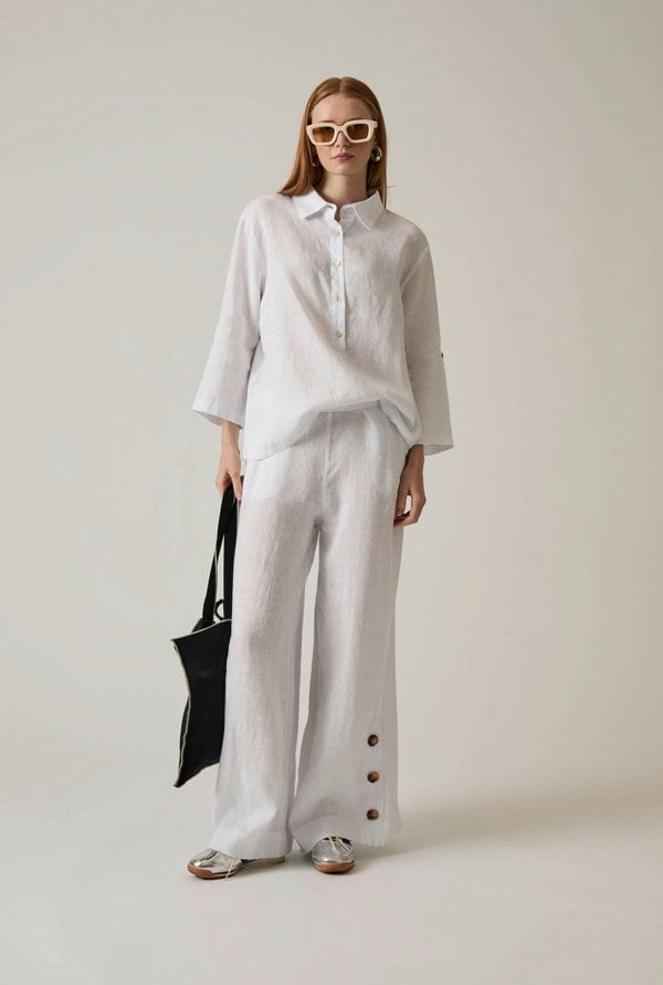 White linen blouse with button front and roll tabs