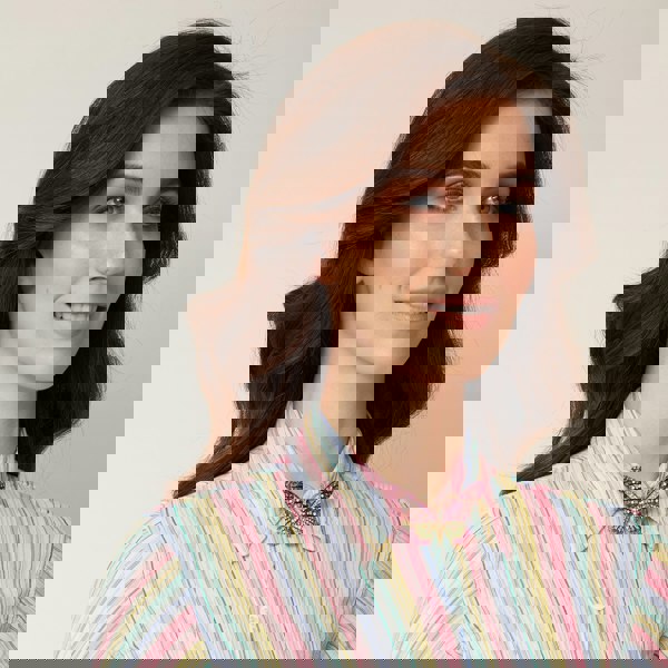 large butterfly brooch in pink crystal worn on neckline