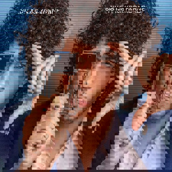 Sapil Solid 100ml EDT Mens perfume held by a man in a blue jacket