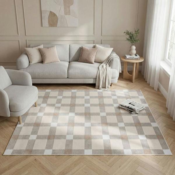 Living room with a checkered rug, gray sofa, and armchair.