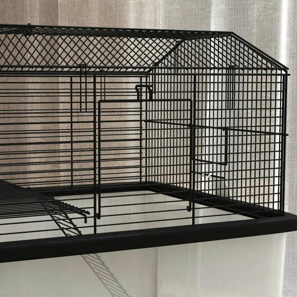 Black wire cage side with platform and front door on the upper tier