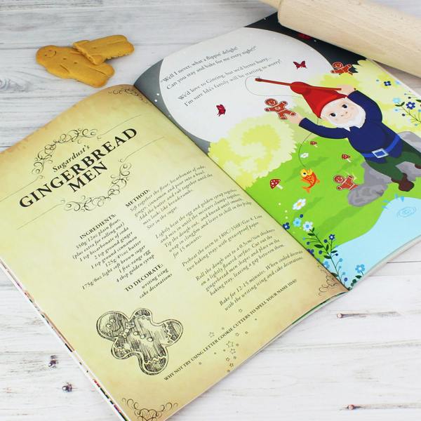 Open view of the Personalised Fairy Baking Adventure storybook featuring Sugardust's Gingerbread Men recipe next to an illustration of a garden gnome holding a gingerbread man with Ida written on it