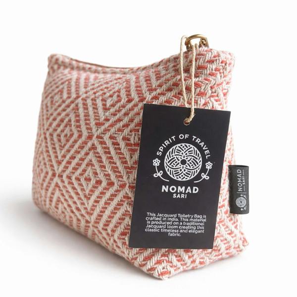 Coral geometric toiletry bag with leather tag and Spirit of Travel label