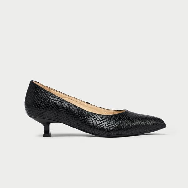 Black low-heeled shoe on a white background