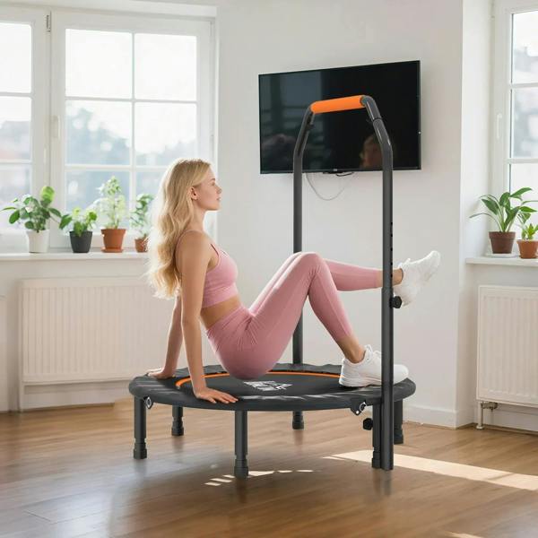 Mini fitness trampoline with orange handle bar; person seated and stretching