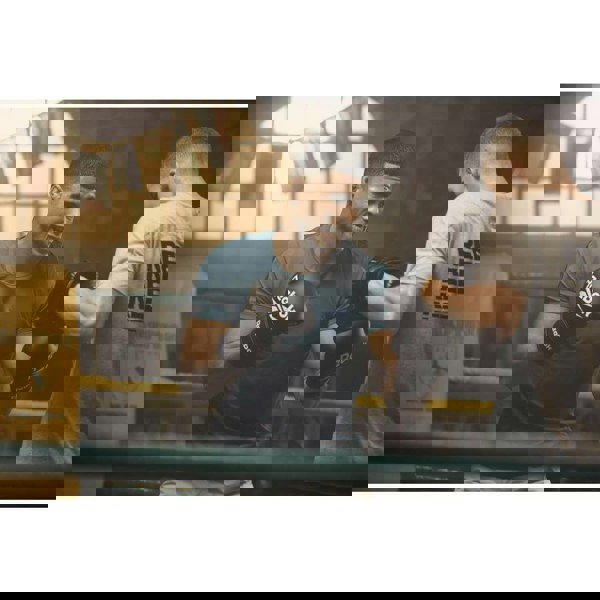 Two men boxing in a boxing ring wearing Reebok Boxing Gloves - White/Black