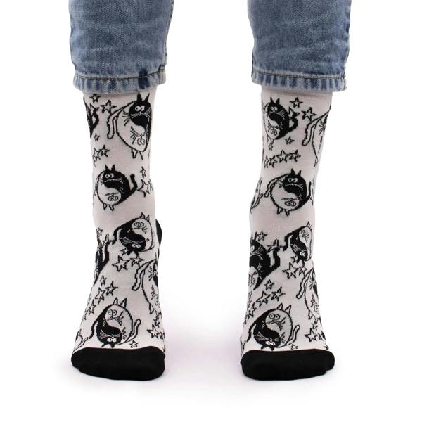 White bamboo crew socks with black cat faces, stars, and striped heel detail
